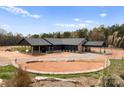 Beautiful exterior of a modern home with a horseshoe drive, stone accents, and lush landscaping at 1565 Shinnville Rd, Cleveland, NC 27013