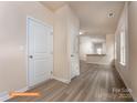 Inviting hallway with durable wood-look floors, leading to an open-concept area with a kitchen and counter seating at 1630 Troon Dr, Salisbury, NC 28144