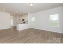 Bright, open-concept living room with light wood floors and ample natural light at 1630 Troon Dr, Salisbury, NC 28144
