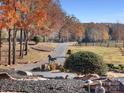 Long driveway leading to home with autumn trees at 172 Tuckertown Rd, New London, NC 28127
