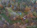Aerial view of the property with a house, RV, and wooded area at 2073 Mauney Rd, Bessemer City, NC 28016