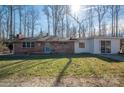 Charming brick home with a blue door and an addition with glass patio doors at 2073 Mauney Rd, Bessemer City, NC 28016