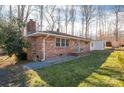 Charming brick home with a blue door and manicured landscape at 2073 Mauney Rd, Bessemer City, NC 28016