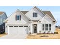 White two-story house with gray shutters, a two-car garage, and landscaping at 4219 Moxie Way, Charlotte, NC 28215