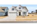 Two-story house with white siding, gray shutters, and a two-car garage at 4219 Moxie Way, Charlotte, NC 28215