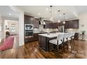 Spacious kitchen with dark cabinetry, stainless steel appliances, and an island at 4219 Moxie Way, Charlotte, NC 28215