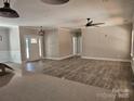 Bright, open living room with wood-look flooring and large windows, creating an inviting and airy atmosphere at 609 Shiloh Unity Rd, Lancaster, SC 29720