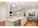 Island kitchen with granite countertops and stainless steel dishwasher at 6411 Aldworth Ln, Charlotte, NC 28226