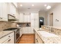 Features granite counters, stainless appliances, stylish backsplash and hardwood floors at 6411 Aldworth Ln, Charlotte, NC 28226
