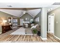 Spacious living room with vaulted ceilings, L-shaped sectional sofa, and fireplace at 9100 Pine Springs Ct, Huntersville, NC 28078