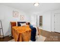 Bright bedroom with an orange comforter and access to a full bathroom at 1001 Archdale Dr, Charlotte, NC 28217