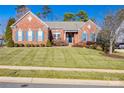 Brick home with a well-manicured lawn at 1117 Butterburr Dr, Matthews, NC 28104