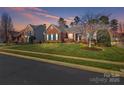 Two-story brick homes on a tree-lined street at 1117 Butterburr Dr, Matthews, NC 28104