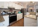 Modern kitchen with granite counters, stainless steel appliances, and white cabinetry at 115 Tradewinds Ct, Mooresville, NC 28115