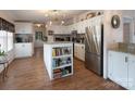 Spacious kitchen with granite countertops, white cabinets, and stainless steel appliances at 115 Tradewinds Ct, Mooresville, NC 28115