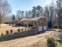 Brick home with attached garage and a spacious yard at 133 Devine St, Stanley, NC 28164