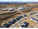 Aerial view of a residential neighborhood with houses, roads, and a school at 139 Crownpiece St, Troutman, NC 28166