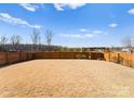 Large backyard with a wooden privacy fence and open grassy area at 139 Crownpiece St, Troutman, NC 28166