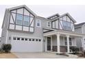 Two-story house with gray siding, white trim, and a welcoming front porch at 19117 Hawk Haven Ln, Charlotte, NC 28278