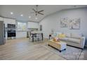 Open concept kitchen with white cabinets, stainless steel appliances, and granite countertops at 2025 Sloan Dr, Charlotte, NC 28208