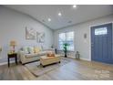 Bright living room with vaulted ceilings and neutral decor at 2025 Sloan Dr, Charlotte, NC 28208