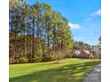 House nestled in a wooded area with a large grassy yard at 2044 Standing Timber Rd, Lancaster, SC 29720