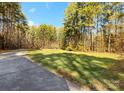 Long driveway leading to a home surrounded by trees at 2044 Standing Timber Rd, Lancaster, SC 29720