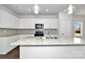 Modern kitchen with white cabinets, granite countertops, and stainless steel appliances at 2242 Catawba Trace Dr, Catawba, NC 28609