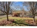 Inviting home featuring a cozy front porch with seating and a well-maintained yard at 2407 Brookside Ave, Kannapolis, NC 28081