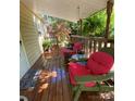 A comfortable, covered porch featuring wooden flooring, chairs with plush cushions, and garden view at 2407 Brookside Ave, Kannapolis, NC 28081