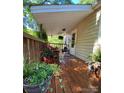 A covered porch with potted plants and foliage, creating a tranquil outdoor space at 2407 Brookside Ave, Kannapolis, NC 28081