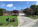 Brick ranch home with attached garage and mature trees at 2509 Calgary Pl, Concord, NC 28027