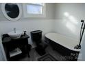 Bathroom with black clawfoot tub and pedestal sink at 303 N Gaston St, Kings Mountain, NC 28086