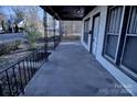 Inviting front porch with black railings at 303 N Gaston St, Kings Mountain, NC 28086