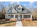 Renovated craftsman home with gray siding, brick accents, and a walkway to the porch at 336 3Rd Se St, Hickory, NC 28602