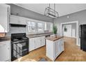 Kitchen with modern appliances, central island, and bright natural light at 34 Lee Rd, Stony Point, NC 28678