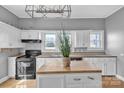 Bright kitchen with white cabinets, central island and black appliances at 34 Lee Rd, Stony Point, NC 28678