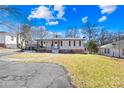 Ranch style home with brick facade and landscaped yard at 404 Ford St, Kannapolis, NC 28083