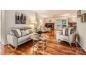 Inviting living room featuring hardwood floors, a cozy seating arrangement, and a decorative fireplace at 4145 Wall St, Charlotte, NC 28209