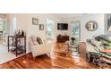 Bright living room with gleaming hardwood floors, modern furniture, and ample natural light, perfect for relaxation at 4145 Wall St, Charlotte, NC 28209
