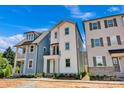 This is a two-story home with a balcony and porch, nestled between neighboring houses at 425 Delburg Mill Alley Dr, Davidson, NC 28036
