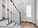 Entryway features hardwood floors, white trim, and a glass-paneled front door at 429 Delburg Mill Alley Dr, Davidson, NC 28036