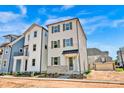 New home with Hardie Board siding, brick detail, gray shutters and a black metal awning at 429 Delburg Mill Alley Dr, Davidson, NC 28036