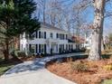 Two-story white house with blue shutters, landscaping, and a curving driveway at 4342 Arborway None, Charlotte, NC 28211