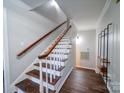 Elegant wooden staircase with white railings and dark hardwood floors at 4440 Beechaven Dr, Rock Hill, SC 29732