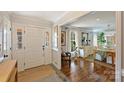 Elegant entryway with hardwood floors, a white door, and view into dining area at 6511 Newhall Rd, Charlotte, NC 28270