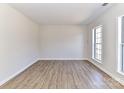 Simple living room with hardwood floors and a large window at 7780 Orchard Park Cir, Harrisburg, NC 28075