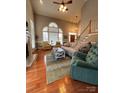 Two story living room with hardwood floors, fireplace and ample seating at 7925 Tottenham Dr, Harrisburg, NC 28075