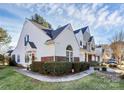 Townhome with brick and white siding, showcasing a side view at 8927 Bryant Field Cir, Charlotte, NC 28277