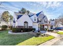 Two-story townhome with gray and white siding, landscaping, and driveway at 8927 Bryant Field Cir, Charlotte, NC 28277